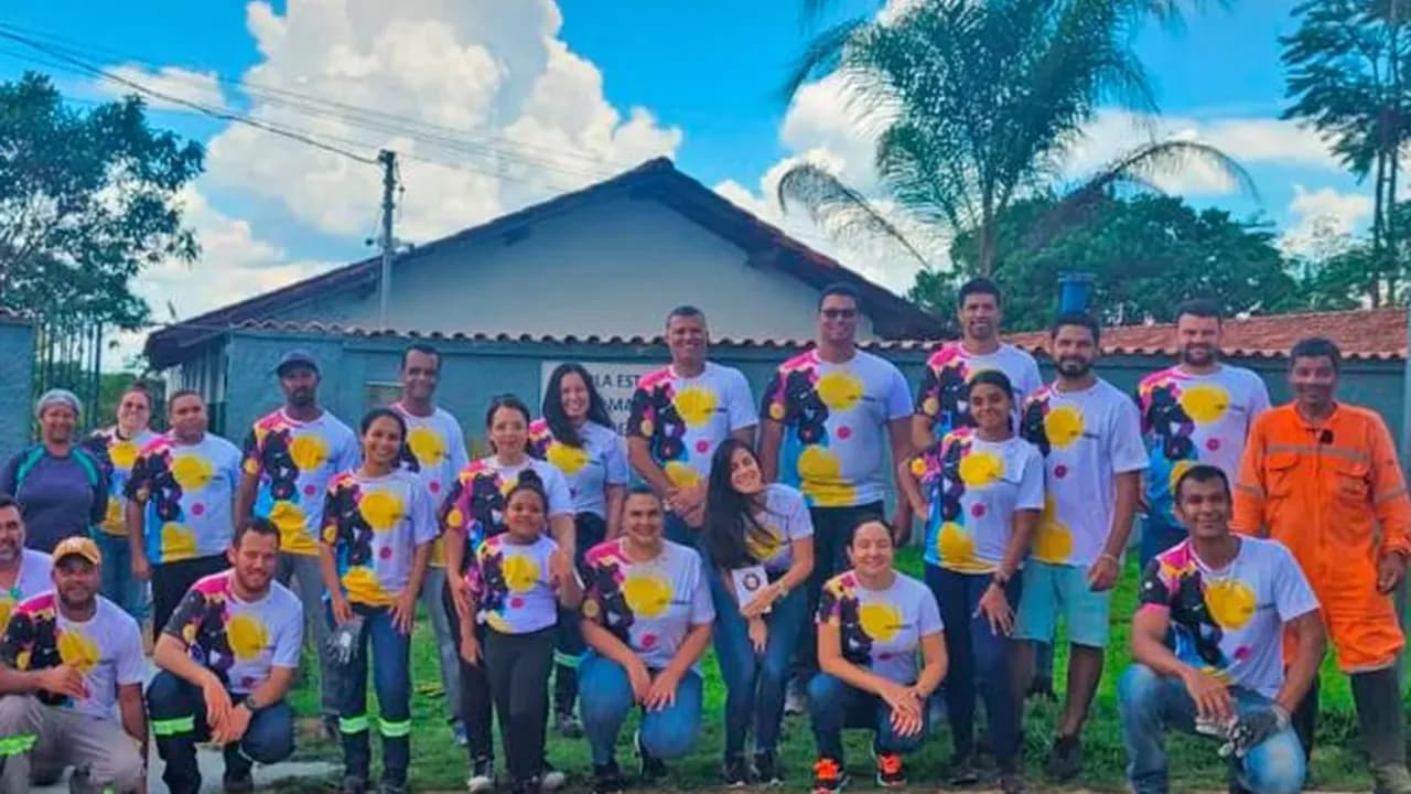 Grupo de voluntários reunido em praça durante ação de revitalização de espaço público